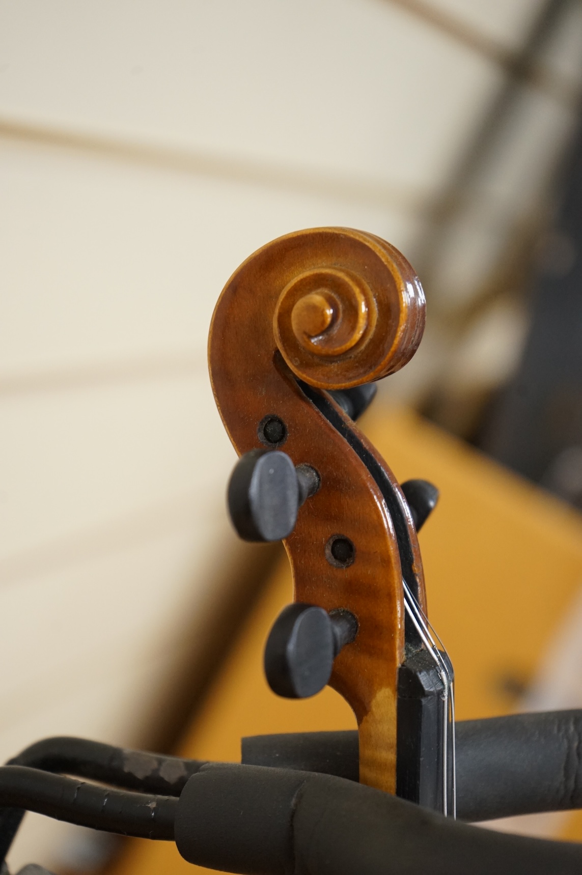 Five cased 20th century violins, including; a German violin, two Czech violins, a three-quarter size violin with a label for Bienfait, and a Romanian quarter size violin, all in cases or the remains of cases.